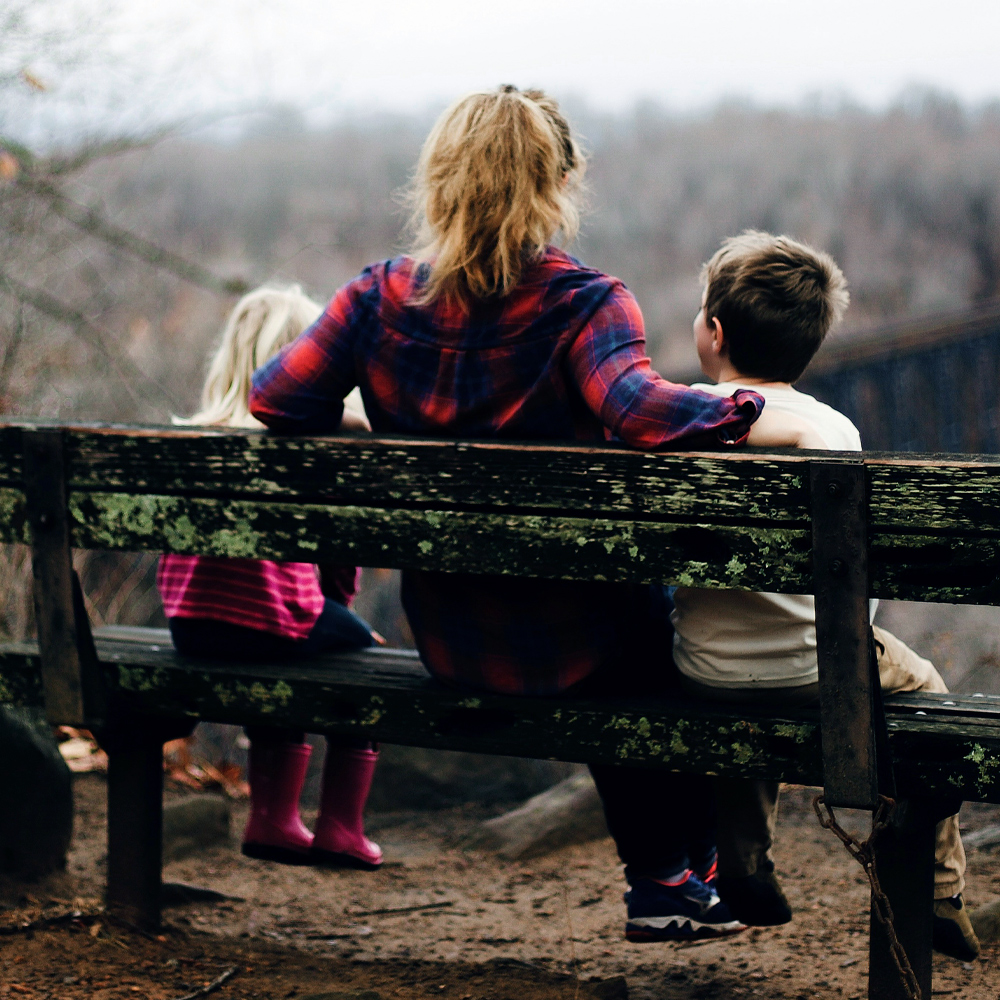 A woman and two kids outside for a hike